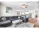 Open living room with L-shaped sectional and view of kitchen at 181 Glenwood Pl, Kenly, NC 27542