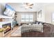 Bright living room featuring a cozy fireplace and large TV at 181 Glenwood Pl, Kenly, NC 27542