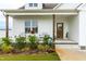 Front porch with rocking chairs and landscaping at 181 Glenwood Pl, Kenly, NC 27542