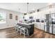 Modern kitchen with island, stainless steel appliances, and hardwood floors at 181 Glenwood Pl, Kenly, NC 27542
