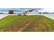 Large grassy backyard with a fenced perimeter and a hot tub at 181 Glenwood Pl, Kenly, NC 27542