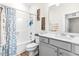 Clean bathroom with a tub shower, gray vanity, and updated fixtures at 181 Glenwood Pl, Kenly, NC 27542