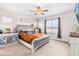 Main bedroom with grey upholstered bed and large window at 181 Glenwood Pl, Kenly, NC 27542