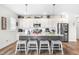 Modern kitchen with island, stainless steel appliances, and hardwood floors at 181 Glenwood Pl, Kenly, NC 27542