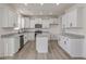 Modern kitchen with white cabinets, granite countertops, and a large island at 579 Winding Creek Dr, Lillington, NC 27546