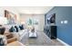 Bright living room featuring a comfortable sofa and large windows at 125 Holmes Corner Dr, Smithfield, NC 27577