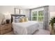 Cozy bedroom with a queen-size bed, nightstand and large windows at 125 Holmes Corner Dr, Smithfield, NC 27577