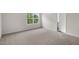 Carpeted bedroom with window and access to bathroom at 236 Holton St, Smithfield, NC 27577
