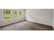 Bright bedroom with wood-look flooring and large windows offering natural light at 236 Holton St, Smithfield, NC 27577