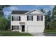 Two-story home with white siding, black shutters, and a two-car garage at 241 Holton St, Smithfield, NC 27577