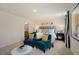 Main bedroom with king-size bed and two teal armchairs at 241 Holton St, Smithfield, NC 27577