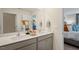 Double vanity bathroom with a large mirror and view of a bedroom at 241 Holton St, Smithfield, NC 27577
