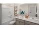 Bathroom with a shower tub combo, double vanity, and decorative butterfly art at 241 Holton St, Smithfield, NC 27577
