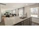 Kitchen island with granite countertops, double sink, and views into the living room at 241 Holton St, Smithfield, NC 27577