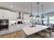 Modern kitchen features white cabinets, stainless steel appliances, and a large island at 904 Delano Dr, Knightdale, NC 27545