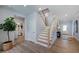 Elegant staircase with light wood and white railings leads to the second floor at 904 Delano Dr, Knightdale, NC 27545