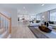 Open living room and kitchen with hardwood floors, island, and modern appliances at 904 Delano Dr, Knightdale, NC 27545