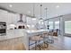 Modern kitchen with white cabinets, stainless steel appliances, and a breakfast bar at 904 Delano Dr, Knightdale, NC 27545