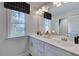 Double vanity bathroom with a window and mirror at 904 Delano Dr, Knightdale, NC 27545