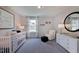 Well-lit Bedroom with crib, sitting chair, and stylish decor at 904 Delano Dr, Knightdale, NC 27545