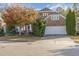 Brick home with a large white garage door and landscaping at 719 Allforth Pl, Cary, NC 27519