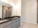 Double vanity bathroom with dark marble countertops and gray cabinets at 103 Brandy Ml, Pittsboro, NC 27312
