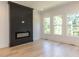Living room with a modern fireplace and hardwood floors at 103 Brandy Ml, Pittsboro, NC 27312