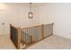 Upstairs hall with wood railing, chandelier and carpet at 103 Brandy Ml, Pittsboro, NC 27312