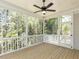 Relaxing screened porch with wood flooring and ceiling fan overlooking wooded area at 103 Brandy Ml, Pittsboro, NC 27312