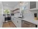 Modern kitchen with white cabinets, quartz countertops, and stainless steel appliances at 2707 N Roxboro Rd, Durham, NC 27704