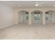 Open basement recreation area with multiple windows and ceiling fan at 719 Allforth Pl, Cary, NC 27519