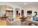 Open living room with hardwood floors, fireplace, and access to kitchen at 719 Allforth Pl, Cary, NC 27519