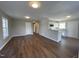 Open living area with hardwood floors and a view of the kitchen and dining area at 707 Richmond Ave, Burlington, NC 27217