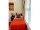 Cozy bedroom with orange bedding and large window with blinds at 1633 Snow Mass Way, Durham, NC 27713