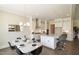 Modern kitchen with white cabinets, large island, and hardwood floors at 2810 Huxley Way, Apex, NC 27502