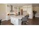 Modern kitchen with white cabinets, large island, quartz countertops, and stainless steel appliances at 2892 Huxley Way, Apex, NC 27502