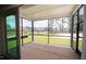 Relaxing screened porch with wood flooring and backyard view at 2892 Huxley Way, Apex, NC 27502