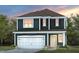 Two-story dark green house with white garage door and light-colored accents at 2892 Huxley Way, Apex, NC 27502