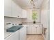 Bright laundry room with white cabinets and a view of the backyard at 4022 Fernbank Way, Youngsville, NC 27596