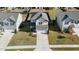 Aerial view of a two-story house with a gray roof and white siding, a driveway, and a small front yard at 2117 Attend Xing, Fuquay Varina, NC 27526