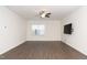 Spacious living room featuring hardwood floors, a ceiling fan, and a large window at 2117 Attend Xing, Fuquay Varina, NC 27526