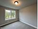 Well-lit bedroom with neutral carpeting and window at 132 S Mistflower St, Clayton, NC 27520