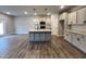 Modern kitchen with gray cabinets, center island and stainless steel appliances at 132 S Mistflower St, Clayton, NC 27520