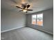 Spacious bedroom with neutral carpeting and large window at 132 S Mistflower St, Clayton, NC 27520