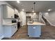 Modern kitchen with island, stainless steel appliances and gray cabinets at 132 S Mistflower St, Clayton, NC 27520