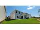 Rear view of a two-story home showcasing a patio and backyard at 1071 Cherry Stem Rd, Haw River, NC 27258