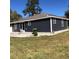 Exterior view of a dark gray house with a patio at 876 Vanco Mill Rd, Henderson, NC 27537