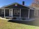 Newly renovated home with a dark blue exterior and front porch at 876 Vanco Mill Rd, Henderson, NC 27537