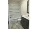 Bathroom with bathtub, shower, and gray vanity at 876 Vanco Mill Rd, Henderson, NC 27537