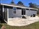 Rear view of a dark gray house with patio and steps at 876 Vanco Mill Rd, Henderson, NC 27537